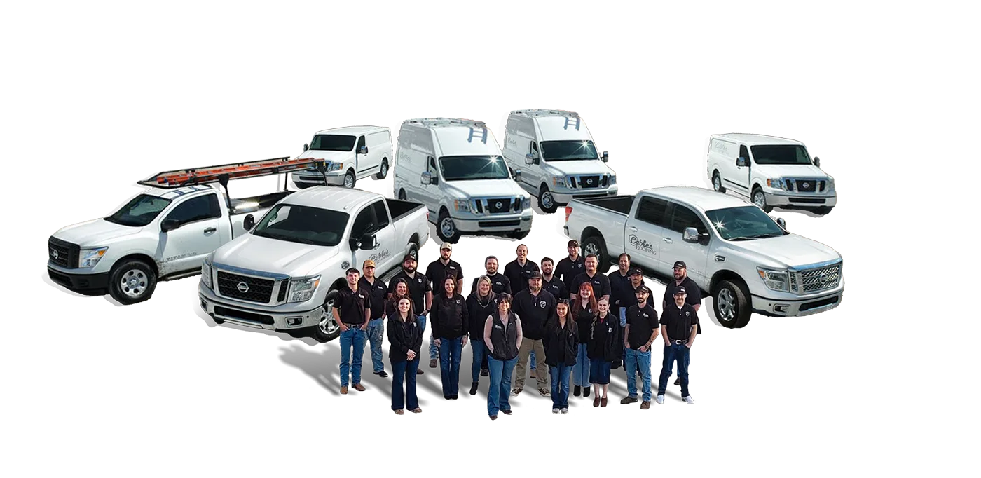 The Cable's Roofing team standing in front of their white work trucks