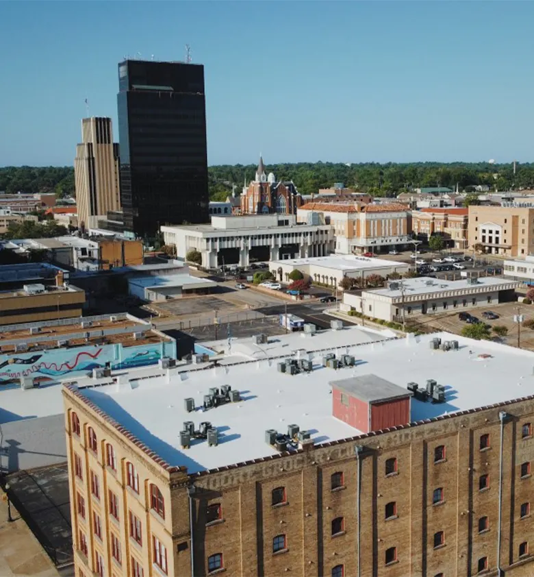 Moore Grocery Lofts roof with downtown Tyler behind it