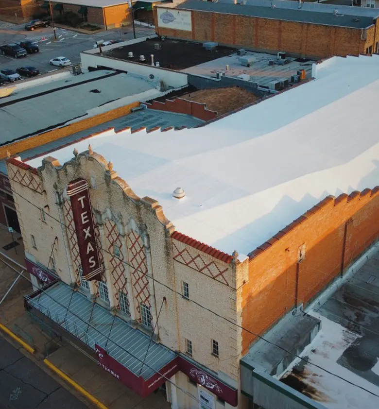 Downtown storefront roof beside an old theatre sign