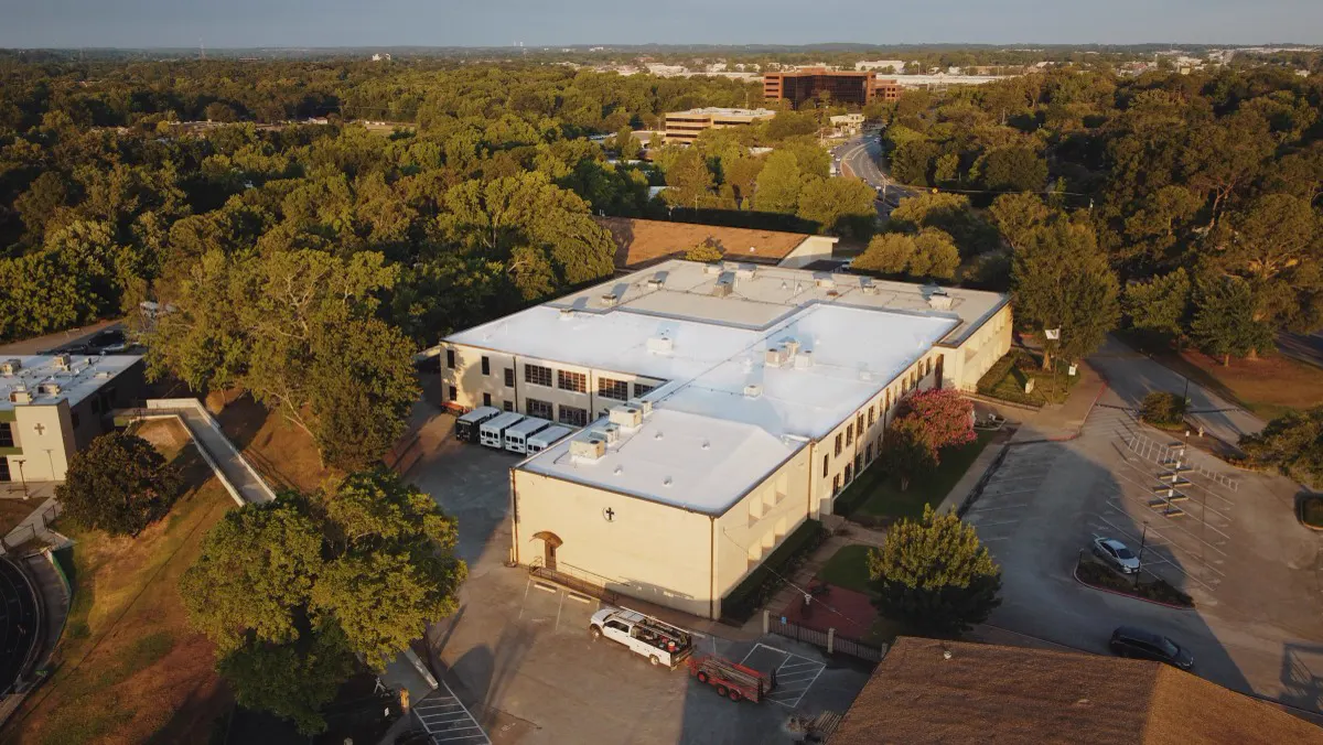 White TPO roof on a commercial building, seen from a drone